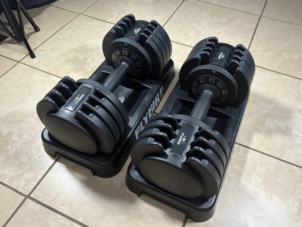 Flybird adjustable dumbbells (11-55 lb) seated in their cradle on the floor